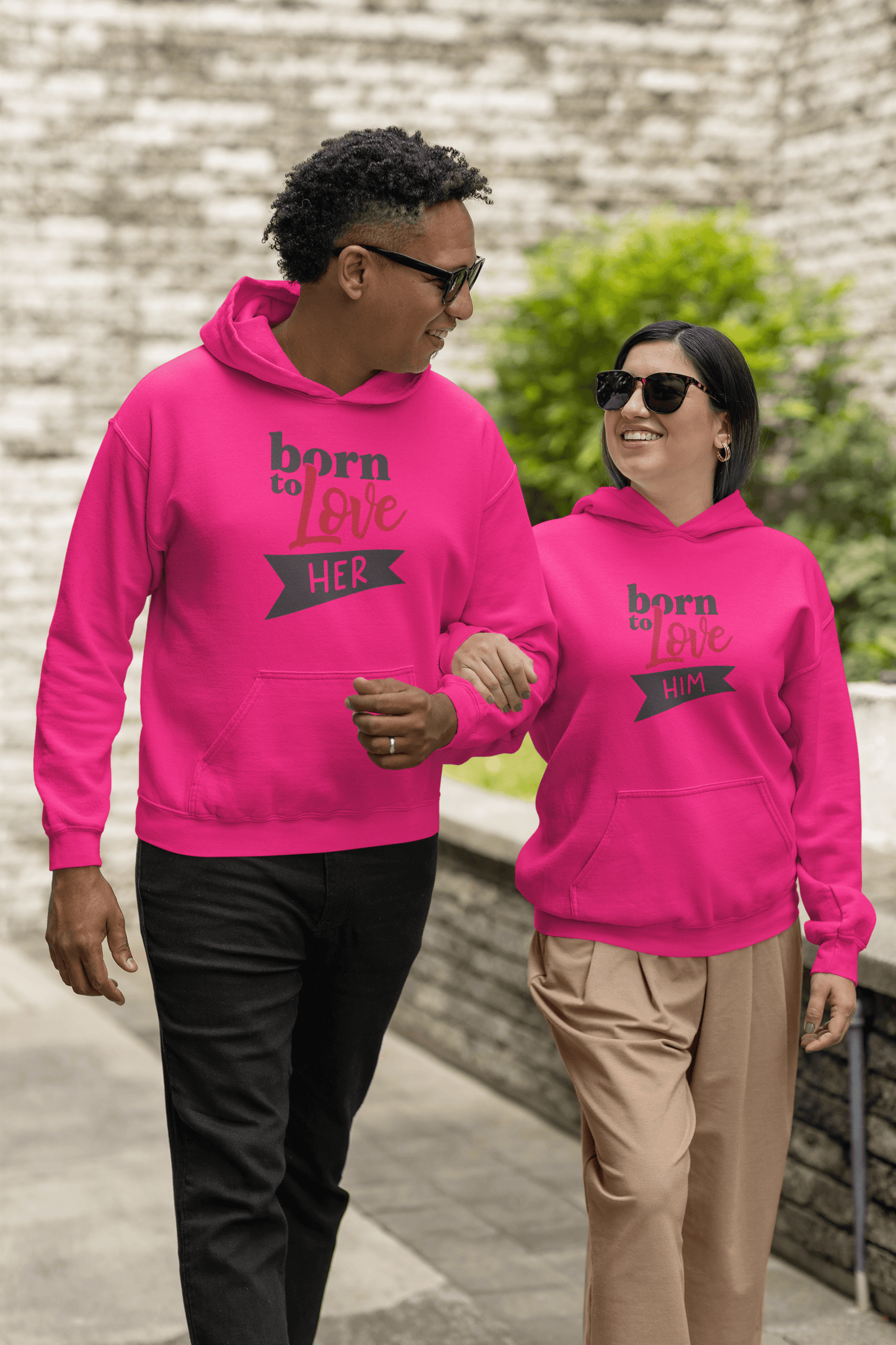 Couple wearing matching pink Born to Love hoodie set, showcasing luxury and stylish comfort for any occasion.
