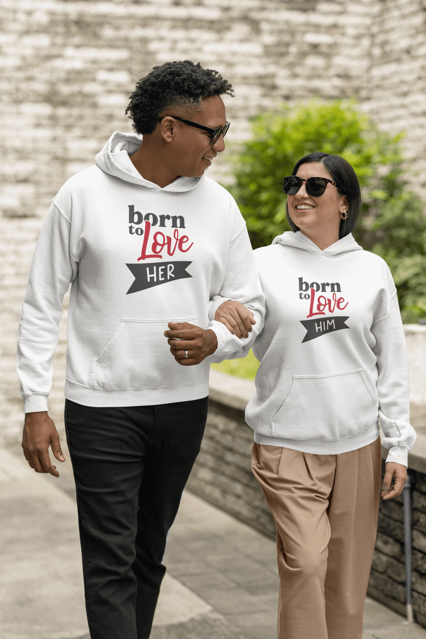 Couple wearing Born to Love Hoodie Set, with 'HER' and 'HIM' designs, showcasing stylish comfort and elegance.